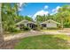 Well-maintained single-story home with lush landscaping and a circular driveway at 2108 Silver Leaf Ct, Longwood, FL 32779