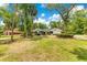 Lovely front yard featuring lush green grass, mature trees, and a well-maintained house at 2108 Silver Leaf Ct, Longwood, FL 32779