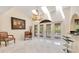Bright living room featuring skylights, a chandelier, and floor-to-ceiling windows overlooking the pool at 2108 Silver Leaf Ct, Longwood, FL 32779