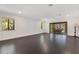 Elegant living room with dark wood floors and large glass doors that open to the outside patio at 2108 Silver Leaf Ct, Longwood, FL 32779