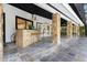 Covered outdoor bar features stone accents, seating, and slate flooring for entertaining at 2108 Silver Leaf Ct, Longwood, FL 32779