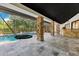 Expansive screened pool area with a hanging swing, stone columns, and outdoor bar perfect for entertaining at 2108 Silver Leaf Ct, Longwood, FL 32779