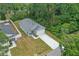 Aerial view of a gray single-Gathering home featuring a driveway and green lawn at 2618 Sidney Ave, Orlando, FL 32810