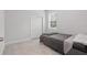 This bedroom has tile floors, neutral paint, a sliding door closet and a window at 2618 Sidney Ave, Orlando, FL 32810