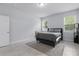This bedroom features tile flooring, neutral paint and two windows for natural light at 2618 Sidney Ave, Orlando, FL 32810