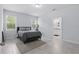 This bedroom has tile floors, two windows, and neutral paint, with an ensuite bathroom at 2618 Sidney Ave, Orlando, FL 32810