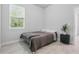 This bedroom features tile floors, neutral paint, one window and modern decor at 2618 Sidney Ave, Orlando, FL 32810