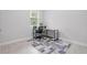 This office features tile flooring, neutral paint, a large window and a modern desk at 2618 Sidney Ave, Orlando, FL 32810