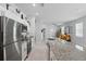 Bright open kitchen features white cabinetry, granite countertops, and modern stainless steel appliances at 2618 Sidney Ave, Orlando, FL 32810