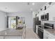 Modern kitchen boasts white cabinets, granite countertops, stainless steel appliances, and natural light at 2618 Sidney Ave, Orlando, FL 32810