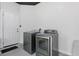 Modern laundry room featuring a side-by-side washer and dryer set and white door at 2618 Sidney Ave, Orlando, FL 32810