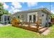 Inviting back deck features outdoor seating and potted plants, perfect for relaxation at 2707 E Marks St, Orlando, FL 32803
