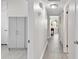 Bright hallway with neutral paint, tile flooring, and access to multiple rooms at 2707 E Marks St, Orlando, FL 32803