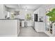 Bright kitchen featuring white cabinets, stainless steel appliances, and a convenient pot rack above at 2707 E Marks St, Orlando, FL 32803