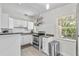 Well-maintained kitchen featuring white cabinets, stainless steel appliances, and lots of natural light at 2707 E Marks St, Orlando, FL 32803