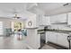 Open-concept living area with an eat-in kitchen area, modern decor, and tile flooring at 2707 E Marks St, Orlando, FL 32803