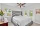 Comfortable bedroom with a tufted headboard bed, ceiling fan, and glass patio doors at 2707 E Marks St, Orlando, FL 32803
