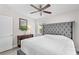 Spacious bedroom featuring soft colors, wooden floors, a ceiling fan, and a large comfortable bed at 2707 E Marks St, Orlando, FL 32803