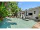 Spacious backyard patio with outdoor seating, grill, and tropical foliage, ideal for entertaining at 2707 E Marks St, Orlando, FL 32803