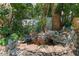 Close up of a peaceful yard pond with rocks and shrubbery at 2707 E Marks St, Orlando, FL 32803