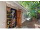 A packed shed with shelves, containers, and wooden double doors at 2707 E Marks St, Orlando, FL 32803