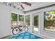 Beautiful sun room with a blue carpet, many windows, and a back door at 2707 E Marks St, Orlando, FL 32803