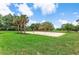 Outdoor volleyball court surrounded by lush green grass and palm trees for recreational fun at 2707 E Marks St, Orlando, FL 32803