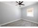 This bedroom features neutral walls, a ceiling fan, a window with natural light and luxury vinyl plank flooring at 2711 Parkland Dr, Winter Park, FL 32789