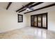 Bright bedroom with travertine floors, ceiling fan, beamed ceilings, and sliding doors to outside at 2711 Parkland Dr, Winter Park, FL 32789