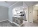 Open-concept view of the kitchen with stainless steel appliances and a stone-clad breakfast bar at 2711 Parkland Dr, Winter Park, FL 32789