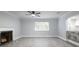 Spacious living room featuring a fireplace, ceiling fan, and large window for ample natural light at 2711 Parkland Dr, Winter Park, FL 32789