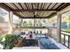 Relax in this screened-in patio featuring a ceiling fan, tropical plants, comfortable seating, and a charming rug at 2711 Parkland Dr, Winter Park, FL 32789