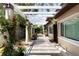 A serene outdoor space with a pergola-covered walkway adorned with potted plants and flowers at 2711 Parkland Dr, Winter Park, FL 32789