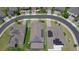Aerial view of a house with a screened-in pool and solar panels on the roof in a manicured neighborhood at 274 Brunswick Dr, Davenport, FL 33837