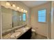 Bathroom featuring a double vanity with granite countertop and glass enclosed shower at 274 Brunswick Dr, Davenport, FL 33837