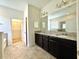 Lovely bathroom features double sink vanity, granite counters, and separate tub and walk-in shower at 274 Brunswick Dr, Davenport, FL 33837