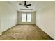 Spacious bedroom features neutral carpet, tray ceiling with fan, and plenty of natural light at 274 Brunswick Dr, Davenport, FL 33837