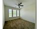 Cozy bedroom with carpet, ceiling fan, and large windows at 274 Brunswick Dr, Davenport, FL 33837