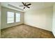 Bedroom featuring carpet, two windows, and a ceiling fan with overhead lighting at 274 Brunswick Dr, Davenport, FL 33837