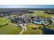 Aerial view of community with a clubhouse, pool, golf course, and lush landscaping at 274 Brunswick Dr, Davenport, FL 33837