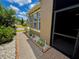 View of the exterior of the home showing brick walkway and small garden at 274 Brunswick Dr, Davenport, FL 33837