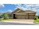 Charming single-story home featuring a three-car garage and well-manicured landscaping at 274 Brunswick Dr, Davenport, FL 33837
