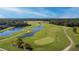 Aerial view of a scenic golf course with water features, rolling greens, and lush trees at 274 Brunswick Dr, Davenport, FL 33837