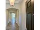Long hallway showcasing tile flooring and arched doorways throughout the home at 274 Brunswick Dr, Davenport, FL 33837