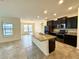 Open-concept kitchen with granite countertops, stainless steel appliances, and an island at 274 Brunswick Dr, Davenport, FL 33837