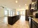 Bright kitchen features granite counters, stainless appliances, and center island with bar seating at 274 Brunswick Dr, Davenport, FL 33837