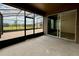 View of the enclosed lanai with brick flooring and view to the fenced backyard at 274 Brunswick Dr, Davenport, FL 33837