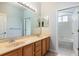 Bathroom with double vanity, large mirror, and separate toilet and shower area at 2780 Running Springs Loop, Oviedo, FL 32765