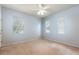 Bright bedroom with light blue walls, ceiling fan, and multiple windows at 2780 Running Springs Loop, Oviedo, FL 32765