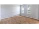Simple bedroom with neutral carpeting and light walls, featuring natural light from two windows at 2780 Running Springs Loop, Oviedo, FL 32765
